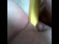 Naughty chick using banana as a dildo